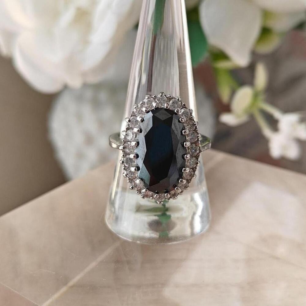 Silver tone oval black glass halo ring with white rhinestones